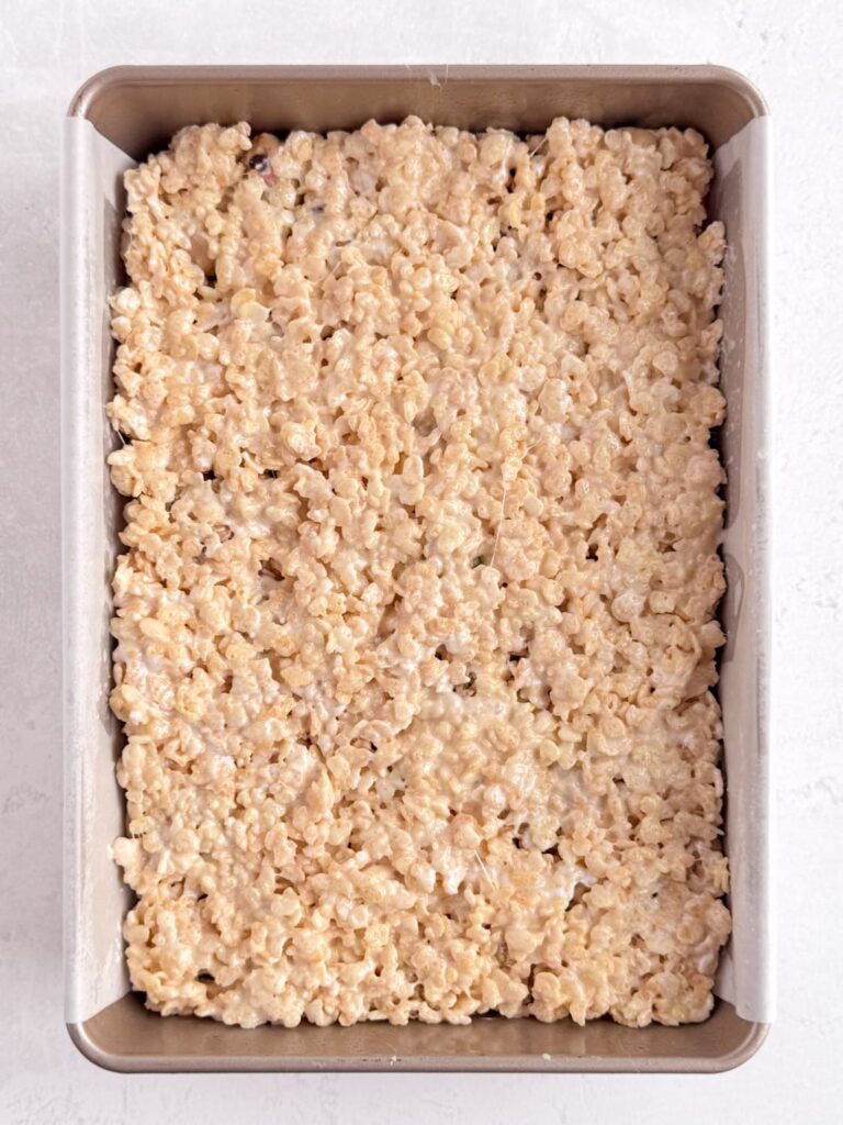 A layer of Rice Krispie treat pressed into a baking pan.