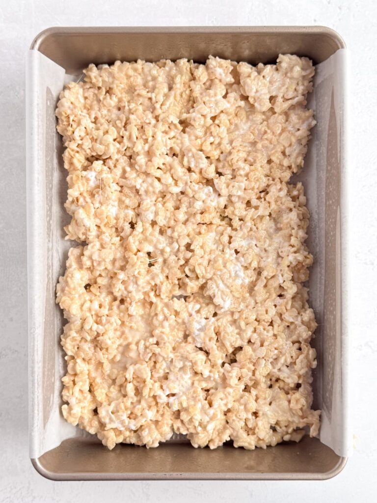 The Rice Krispie treat mixture pressed into a baking sheet pan.