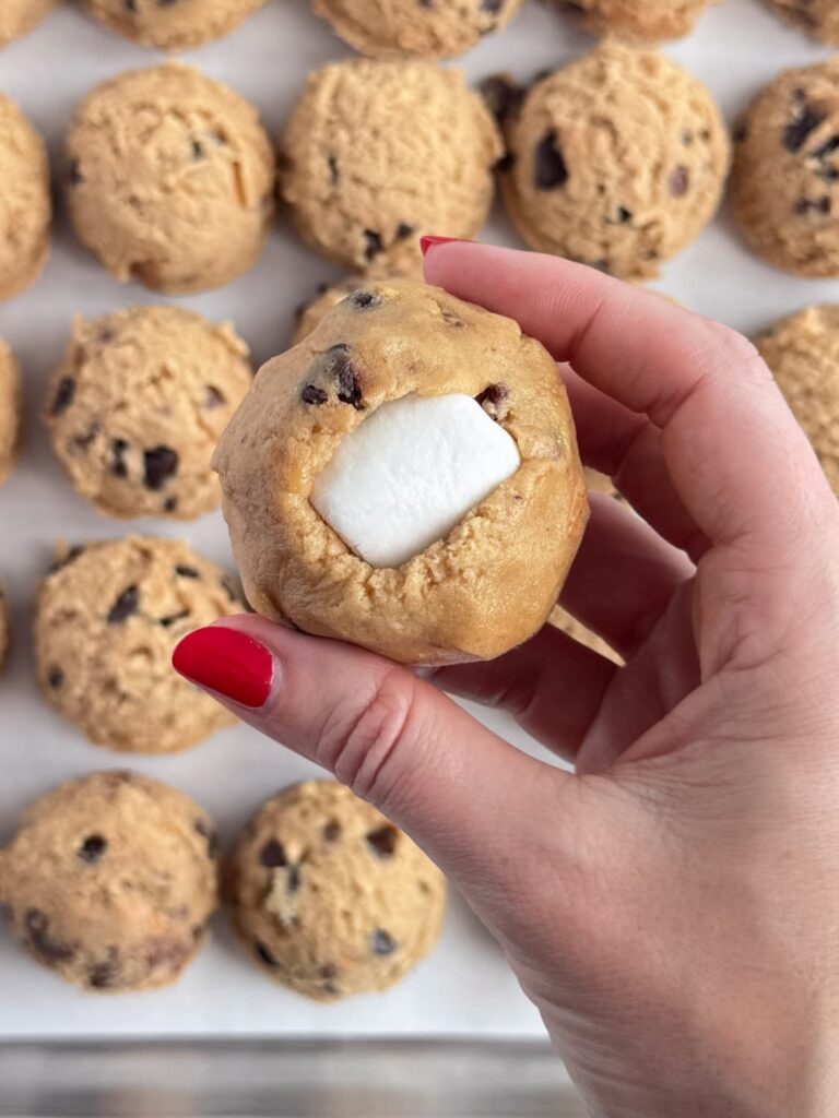 Cookie dough ball with a marshmallow in the center.