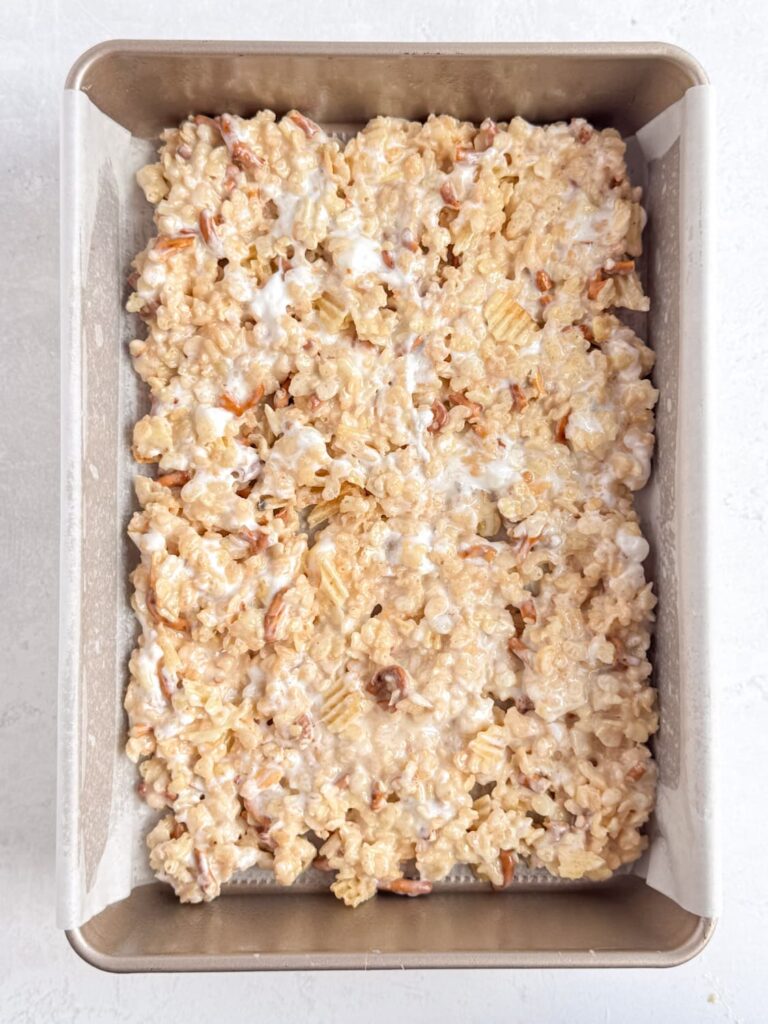 Rice Krispie treat mixture pressed into a pan.