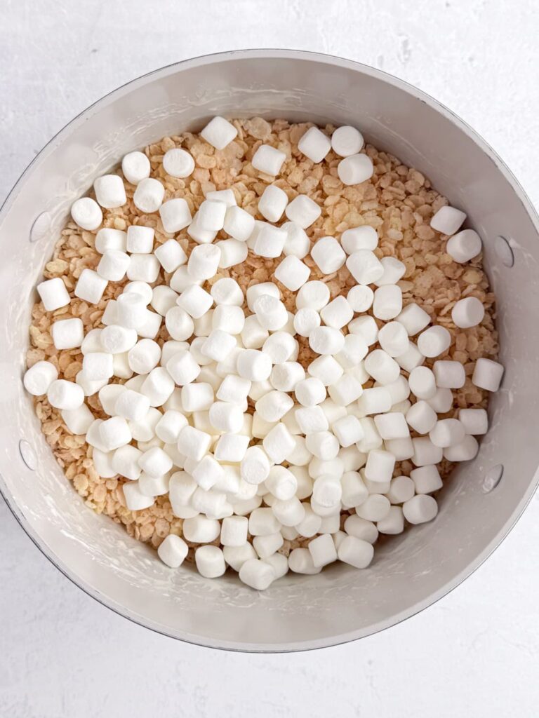 Rice Krispies cereal and mini marshmallows in a saucepan.