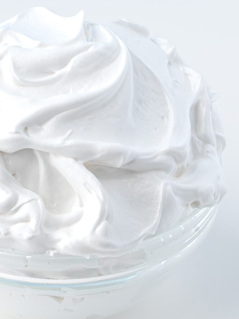 Homemade marshmallow fluff in a mixing bowl.