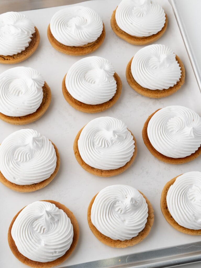 Marshmallow fluff piped on to the peanut butter cookies.