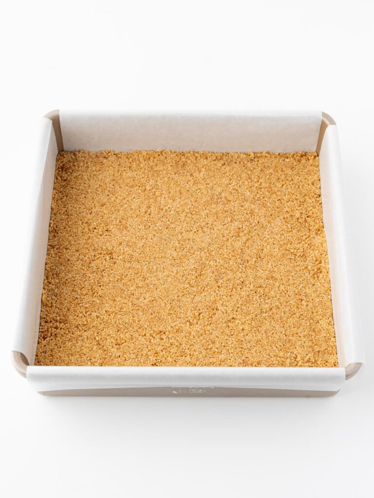 Graham cracker crumbs pressed into a pan.