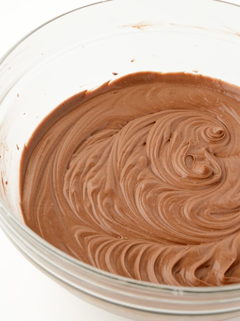 Chocolate cheesecake filling in a mixing bowl.
