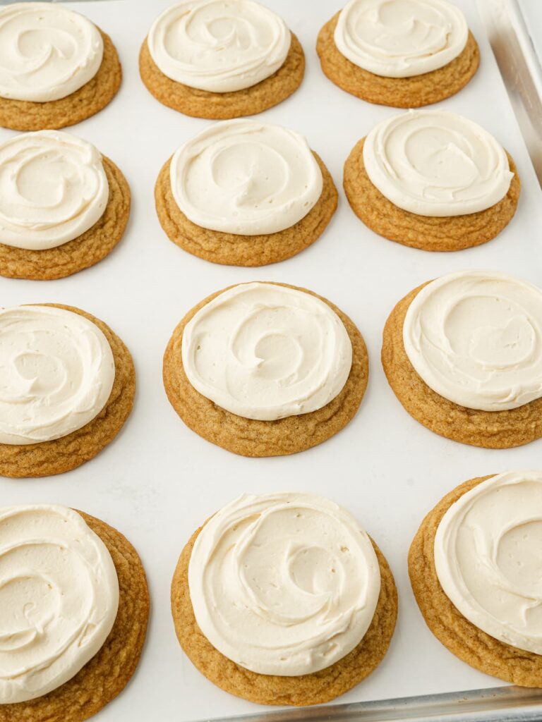 Salted caramel buttercream piped onto a cinnamon brown sugar cookie with a raised edge.